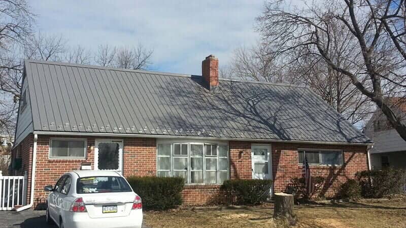 Red brick Cape Cod with a new standing seam metal roof