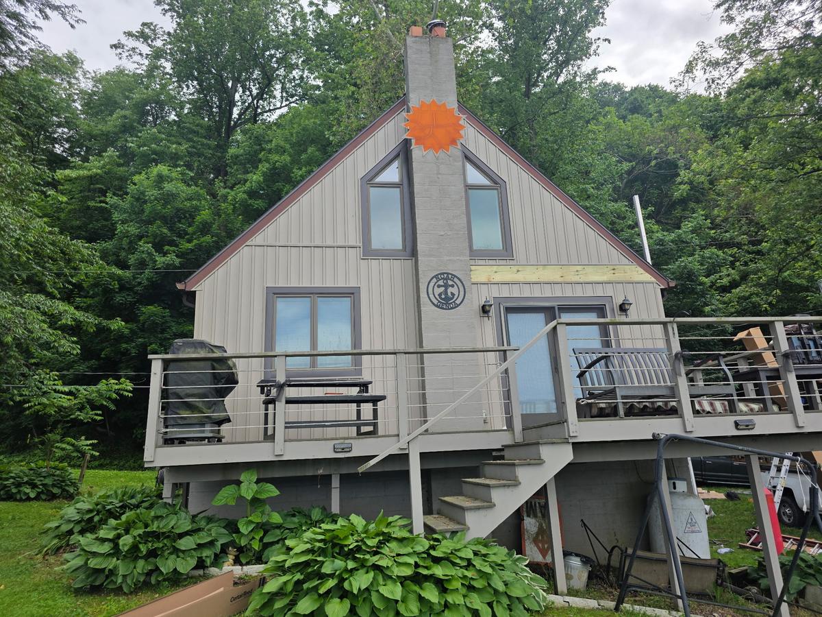 Lakeside cottage with a new architectural shingle roof