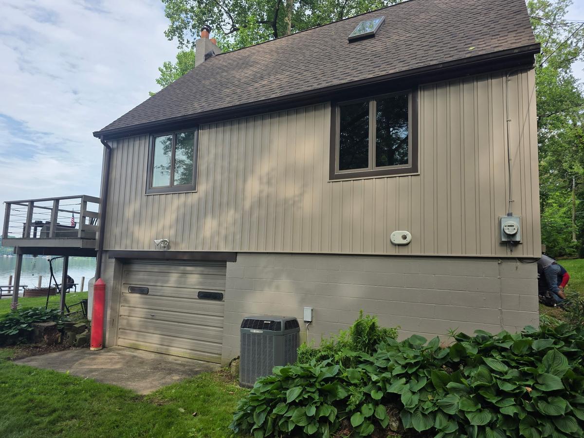 Side elevation of a lake house with a new shingle roof